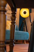 a lamp sitting next to a blue chair at Appartement atypique au coeur des Alpes in Barraux