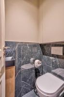a bathroom with a toilet and a black marble wall at 02 - Urban Exclusive in Montorgueil in Paris