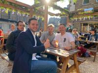 a group of men sitting at a picnic table at Kick Ass Greyfriars (18+) in Edinburgh
