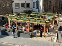 a group of people standing at a farmers market at Kick Ass Greyfriars (18+) in Edinburgh