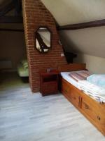 a bedroom with a bed and a mirror in a attic at Le Caux&#39;gîte in Bretteville-du-Grand Caux