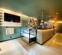 a restaurant with a counter with a display of food at Hotel Apartamento Foz Atlantida in Monte Gordo