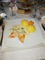 a white plate with food on a table at PENSIUNEA TEOMIR in Pojorîta