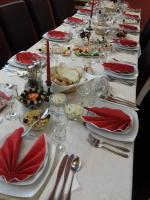 a long table with plates of food on it at PENSIUNEA TEOMIR in Pojorîta