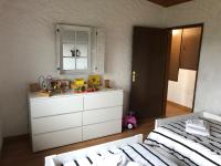 a bedroom with a white dresser with toys on it at LA PETITE MESANGE in Dabo