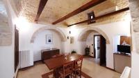 A television and/or entertainment centre at Capodigallo Holiday Trullo Monte Santo