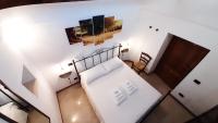 A bed or beds in a room at Capodigallo Holiday Trullo Monte Santo