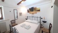 A bed or beds in a room at Capodigallo Holiday Trullo Monte Santo