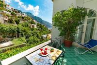 a balcony with a table with food on it at Casa Teresa in Positano