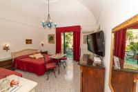 a living room with a bed and a tv at Casa Teresa in Positano