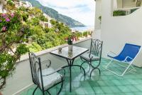 a balcony with a table and chairs and a view at Casa Teresa in Positano