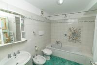 a bathroom with a tub and a toilet and a sink at Casa Teresa in Positano