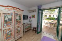 a living room with a large cabinet and a table at Casa Teresa in Positano