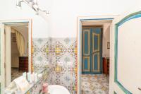 a bathroom with a mirror and a blue door at Casa Teresa in Positano