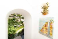 a painting of a church on a wall next to a window at Casa Teresa in Positano