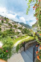 a view of a town with flowers on a hill at Casa Teresa in Positano