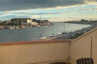 a view of a marina with boats in the water at Appartement calme vue sur l&#39;hérault et la mer in Agde