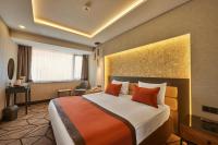 a hotel room with a large bed with orange pillows at Grand Hotel Gulsoy Old City in Istanbul