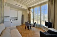 a living room with a couch and a table with chairs at Plaza Mina Suites - Adults Recommended by Luxury Suites Cadiz in Cádiz