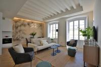 a living room with a white couch and chairs at Plaza Mina Suites - Adults Recommended by Luxury Suites Cadiz in Cádiz