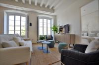a living room with a couch and chairs and a table at Plaza Mina Suites - Adults Recommended by Luxury Suites Cadiz in Cádiz