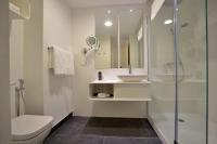 a bathroom with a toilet and a sink and a shower at Plaza Mina Suites - Adults Recommended by Luxury Suites Cadiz in Cádiz