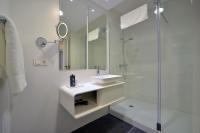 a white bathroom with a sink and a shower at Plaza Mina Suites - Adults Recommended by Luxury Suites Cadiz in Cádiz