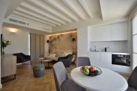 a kitchen and a living room with a table and chairs at Plaza Mina Suites - Adults Recommended by Luxury Suites Cadiz in Cádiz