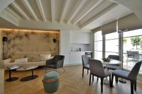 a living room with a couch and a table and chairs at Plaza Mina Suites - Adults Recommended by Luxury Suites Cadiz in Cádiz