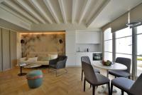 a living room with a couch and a table and chairs at Plaza Mina Suites - Adults Recommended by Luxury Suites Cadiz in Cádiz