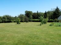 a large grass field with trees and bushes at Holiday Home Les Hortensias - KSD101 by Interhome in Kermaria-Sulard