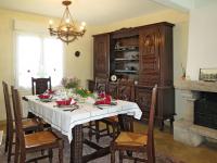 a dining room with a table and a fireplace at Holiday Home Les Hortensias - KSD101 by Interhome in Kermaria-Sulard