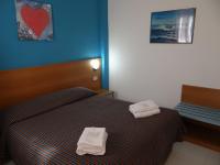 A bed or beds in a room at Hotel Amendola Fiera