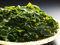 a basket filled with green spinach on a table at Hotel Ace Morioka in Morioka
