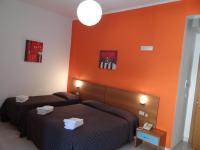 A bed or beds in a room at Hotel Amendola Fiera