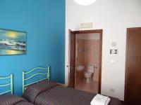 A bed or beds in a room at Hotel Amendola Fiera