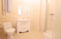 a bathroom with a toilet and a sink and a shower at Gold Bugaz Black Sea Hotel Group in Gribovka