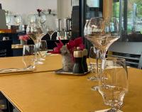 a table with wine glasses on top of it at Nash Suites Airport Hotel in Geneva