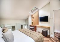 Televízia a/alebo spoločenská miestnosť v ubytovaní DBH – Boutique Hotel Lake Como