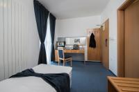 A bed or beds in a room at Felicity Garni Hotel