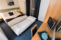 A bed or beds in a room at Felicity Garni Hotel
