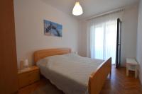 a bedroom with a bed and a window at Apartment Lorela in Malinska
