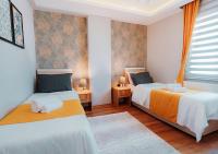 A bed or beds in a room at Umut Apartments