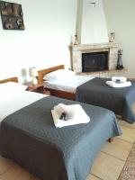 A bed or beds in a room at MARMARI MEGALI AMMOS OASIS Apartment & Studio