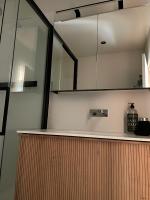 a kitchen with a counter with a sink and a mirror at vakantiehuis Cerise, Luxueus genieten in de Leiestreek in Deinze