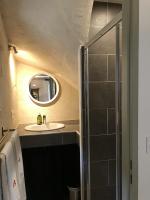 a bathroom with a sink and a mirror at Les Granges Pelloquin in Bernières-sur-Mer