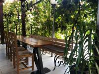 una mesa de madera y un banco en un patio con plantas en Guesthouse Jurcek, en Zreče
