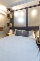 a bedroom with a large white bed with two pillows at The Originals City, Hôtel Hélios, Roanne Nord (Inter-Hotel) in Mably