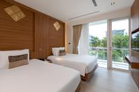 Postel nebo postele na pokoji v ubytování Splash Beach Resort, Maikhao Phuket - SHA Extra Plus