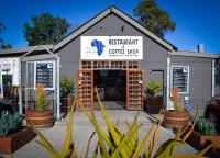 ein Café mit Pflanzen davor in der Unterkunft Maggie May House Boat - Colchester - 5km from Elephant Park in Colchester